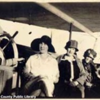 Seven women seated around the wheel of the United States Coast Guard Cutter Pamlico